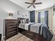 Comfortable bedroom features neutral color scheme, ceiling fan, and natural light at 602 Cabernet Way, Oldsmar, FL 34677