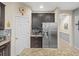 Kitchen nook featuring a stainless steel refrigerator, built-in cabinets and granite countertops at 602 Cabernet Way, Oldsmar, FL 34677