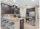 Spacious kitchen with dark wood cabinets, granite countertops, and stainless steel appliances at 602 Cabernet Way, Oldsmar, FL 34677