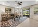 Inviting living room with a cozy sofa, stylish rug, and large windows that flood the space with natural light at 602 Cabernet Way, Oldsmar, FL 34677