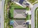 Aerial view of a beautiful home with a backyard, screened lanai, and lush landscaping at 6326 Waves End Pl, Apollo Beach, FL 33572