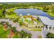 Aerial view of a community pool, playground, recreation center and lake at 6326 Waves End Pl, Apollo Beach, FL 33572
