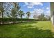 A fully landscaped backyard with mature trees and lawn at 6326 Waves End Pl, Apollo Beach, FL 33572