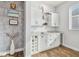 Stylish bar area with white cabinets, wine storage, and a mini-fridge at 6326 Waves End Pl, Apollo Beach, FL 33572