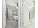 A bedroom and bathroom combination creates a cozy space enhanced by natural light and a functional design at 6326 Waves End Pl, Apollo Beach, FL 33572