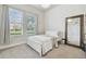 Cozy bedroom featuring a bed, complemented by natural light streaming through the windows, creating a serene retreat at 6326 Waves End Pl, Apollo Beach, FL 33572