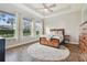 Bedroom boasts natural light, a ceiling fan, and hardwood floors with a large area rug at 6326 Waves End Pl, Apollo Beach, FL 33572