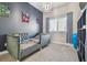Cozy bedroom showcasing a bed with patterned bedding, and a blue accent wall at 6326 Waves End Pl, Apollo Beach, FL 33572