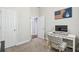 Neutral bedroom with white trim and a desk in the corner at 6326 Waves End Pl, Apollo Beach, FL 33572