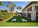 Cornhole area with artificial turf and palm trees in a Gathering-friendly community at 6326 Waves End Pl, Apollo Beach, FL 33572