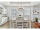 Bright dining area featuring a wood table, chandelier, and white cabinetry with granite countertops at 6326 Waves End Pl, Apollo Beach, FL 33572