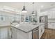 Open-concept kitchen with large island, stainless steel appliances, and breakfast nook at 6326 Waves End Pl, Apollo Beach, FL 33572