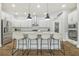 Bright, all-white kitchen featuring granite countertops, stainless steel appliances, and pendant lighting at 6326 Waves End Pl, Apollo Beach, FL 33572