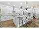 Modern kitchen with white cabinets, granite countertops, large island, and stainless steel appliances at 6326 Waves End Pl, Apollo Beach, FL 33572