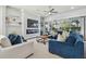 Spacious living room featuring modern decor, a cozy seating area, and large windows with backyard views at 6326 Waves End Pl, Apollo Beach, FL 33572