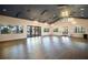 Spacious meeting room features large windows and modern light fixtures, providing an elegant atmosphere at 6326 Waves End Pl, Apollo Beach, FL 33572