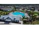 Aerial view of a resort style pool with lounge chairs and a clubhouse nestled within a residential community at 6326 Waves End Pl, Apollo Beach, FL 33572