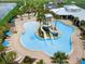 Resort style pool and water slides with many chairs and tables and a lake in the background at 6326 Waves End Pl, Apollo Beach, FL 33572