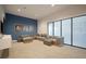 Comfortable theater room with a big sectional couch, ottomans and a movie-themed wall at 6326 Waves End Pl, Apollo Beach, FL 33572