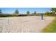 Outdoor sand volleyball court with net, poles, and well-maintained sand surface at 6326 Waves End Pl, Apollo Beach, FL 33572
