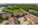 An aerial view showcases condo buildings and surrounding foliage at 6533 Channelside Dr, New Port Richey, FL 34652