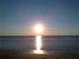 Golden sunrise over a serene beach with calm water at 6533 Channelside Dr, New Port Richey, FL 34652