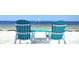 Turquoise Adirondack chairs overlooking the ocean, perfect for relaxation at 6533 Channelside Dr, New Port Richey, FL 34652