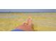 Relaxing view of bare feet in the clear ocean water at the beach at 6533 Channelside Dr, New Port Richey, FL 34652