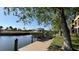 Private boat dock featuring boat lift, waterfront access, and landscaping at 6533 Channelside Dr, New Port Richey, FL 34652