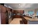 A spacious kitchen boasts stainless steel appliances and rich, dark wood cabinetry at 6533 Channelside Dr, New Port Richey, FL 34652