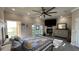 Spacious main bedroom featuring a fireplace, balcony, and decorative ceiling fan at 6533 Channelside Dr, New Port Richey, FL 34652