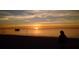A silhouette watches a breathtaking sunset over the water, by the beach at 6533 Channelside Dr, New Port Richey, FL 34652