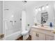 Bright bathroom featuring a tub/shower combo, white vanity, and contemporary lighting at 6920 Lafayette N # 6920, Pinellas Park, FL 33781