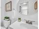 Bathroom featuring a white single vanity, framed art, modern fixtures and natural light at 6920 Lafayette N # 6920, Pinellas Park, FL 33781