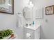 Bright bathroom featuring a white single vanity, framed art, and classic fixtures at 6920 Lafayette N # 6920, Pinellas Park, FL 33781