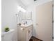 Well-lit bathroom featuring a vanity with marble countertop and wood-look flooring at 6920 Lafayette N # 6920, Pinellas Park, FL 33781
