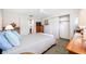 Bedroom with a bed, side tables, carpet and view into the bathroom at 6920 Lafayette N # 6920, Pinellas Park, FL 33781