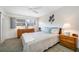 Comfortable bedroom with a ceiling fan, white walls, neutral carpet, and a large window at 6920 Lafayette N # 6920, Pinellas Park, FL 33781