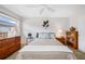 Bedroom showcasing carpet, dresser, end tables and a large window at 6920 Lafayette N # 6920, Pinellas Park, FL 33781