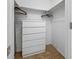 A closet with white walls, carpet, a dresser, and closet rods at 6920 Lafayette N # 6920, Pinellas Park, FL 33781