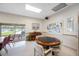 Community game room equipped with round game table, piano, and access to the patio at 6920 Lafayette N # 6920, Pinellas Park, FL 33781