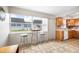 Kitchen with bright natural light, oak cabinets, white appliances, and views of the neighborhood at 6920 Lafayette N # 6920, Pinellas Park, FL 33781