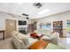 Community lounge with comfortable sofas, bookshelves, and large-screen TV at 6920 Lafayette N # 6920, Pinellas Park, FL 33781