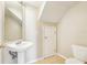 Half bathroom featuring tile floors, pedestal sink, and standard toilet at 7303 E Bank Dr, Tampa, FL 33617
