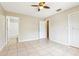 Bedroom with ceramic tile flooring and multiple doors for easy access at 7303 E Bank Dr, Tampa, FL 33617