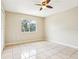 Bedroom with a ceiling fan and ceramic tile floors, offering a clean and neutral space at 7303 E Bank Dr, Tampa, FL 33617