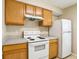 Kitchen featuring tile floors, laminate counters, and white appliances at 7303 E Bank Dr, Tampa, FL 33617