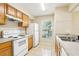 Kitchen featuring tile floors, laminate counters, and white appliances at 7303 E Bank Dr, Tampa, FL 33617