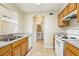 Bright kitchen featuring tile floors, laminate counters, and white appliances at 7303 E Bank Dr, Tampa, FL 33617