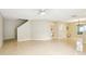 Bright living area featuring tile flooring, a ceiling fan, and seamless access to the kitchen at 7303 E Bank Dr, Tampa, FL 33617